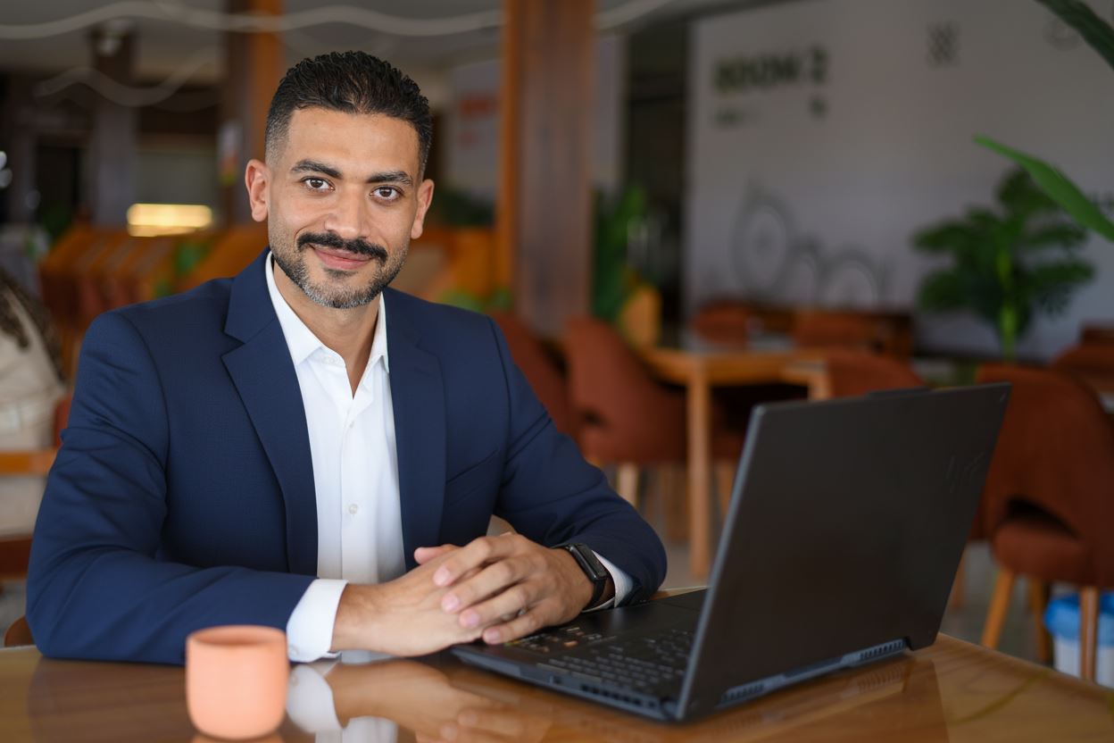 Ahmed Ali at a desk with a laptop